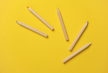Set of wooden colored pencils on yellow background. Creativity, art