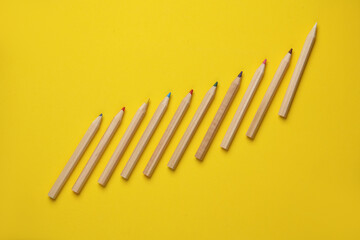 Set of wooden colored pencils on yellow background. Creativity, art