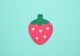 Handmade felt strawberry on a blue background