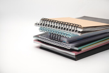 Stack of different notepads on white background