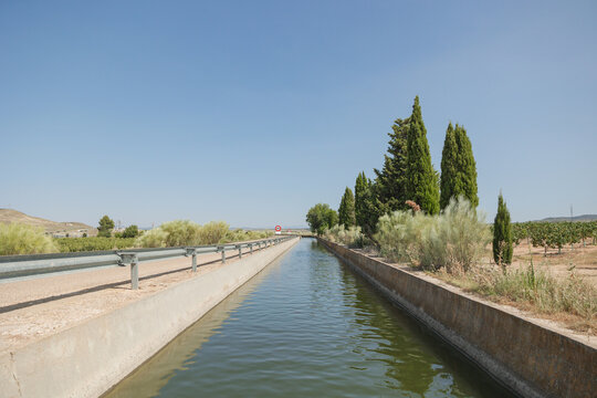 Tranquil irrigation canal amidst lush greenery