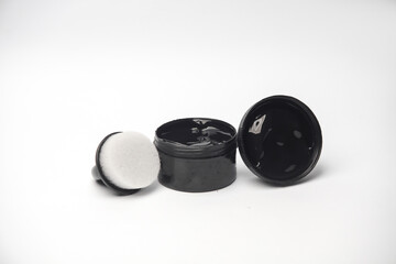 Shoe polish jar with sponge on white background