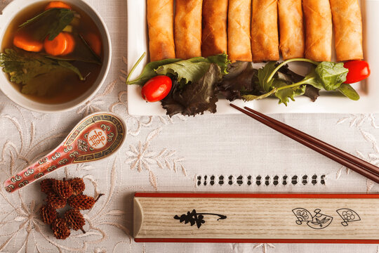Traditional Asian meal with spring rolls and soup