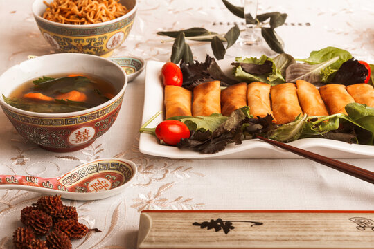 Traditional Asian meal with spring rolls and soup