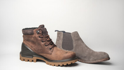 Suede and leather boot on gray background