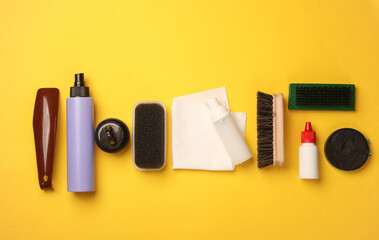 Shoe care products and accessories on a yellow background. Top view. Flat lay