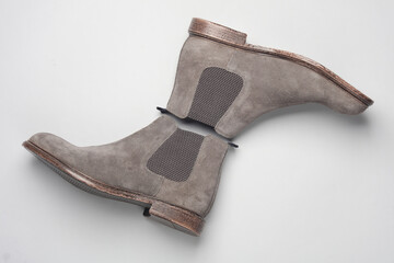 Gray suede Chelsea boots on white background. Top view