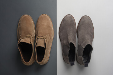 Suede desert and Chelsea boots on dark gray background