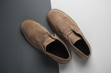 Suede desert boots on gray  background. Top view