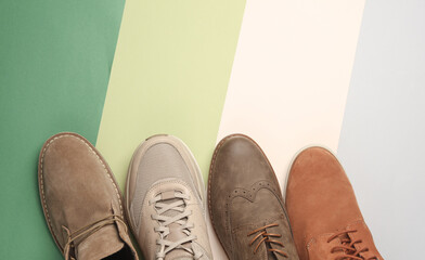 Different men's shoes on a colored background. Top view. Creative fashion layout