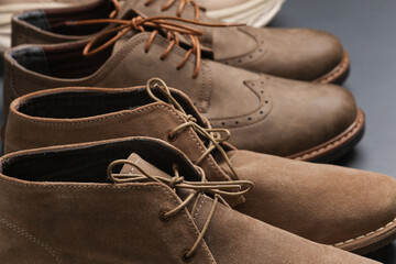 Close-up of men's casual boots on a dark gray background - obrazy, fototapety, plakaty
