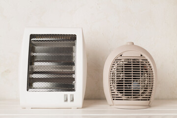 Portable electric heaters on table