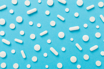 Flat lay with different medical pills and capsules on color background