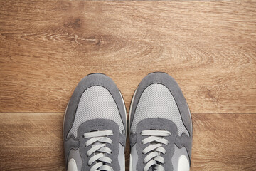 Sports sneakers on wooden floor. Top view