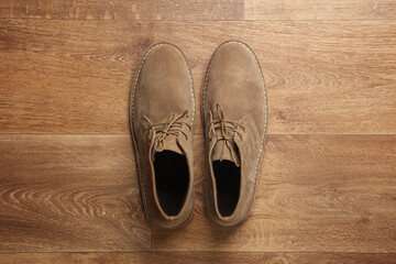 Suede desert shoes on wooden floor