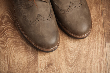 Leather men's brogue shoes on wooden floor