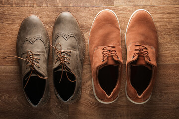 Brogues and suede shoes on the floor. Top view
