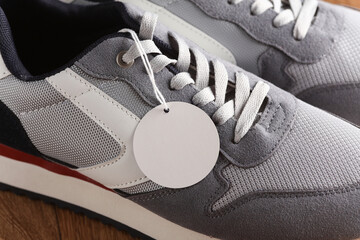 Sports sneakers with a tag on a string. Sale, fashion concept