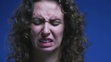 Close-up face of woman feeling disgust and contempt. 20s person feeling strong aversion, rejecting...