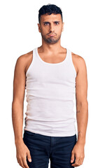 Fototapeta premium Young hispanic man wearing casual clothes depressed and worry for distress, crying angry and afraid. sad expression.