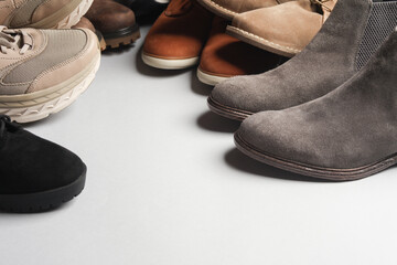 Different shoes on a gray background. Copy space