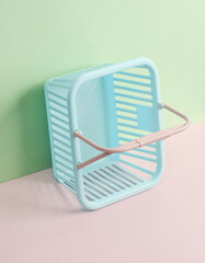 Creative beauty layout with shopping basket on pastel background. Conceptual pop. Minimal fashion still life