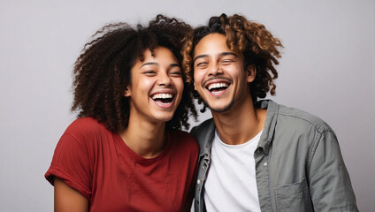 Two interracial best friends laughing and having a good time together in a studio