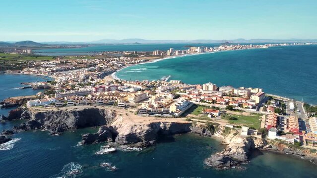 Aerial drone perspective of famous region La Manga, Murcia Province. Spain. "Cabo de Palos" - Cape Palos. Seaside sandspit of Mar Menor in the Region of Murcia. Travel destination. Drone backwards