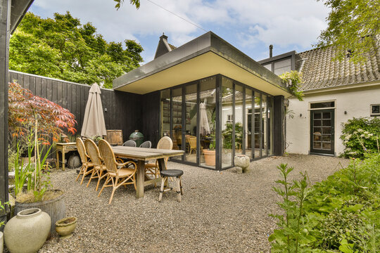 Backyard with furniture and pebbles outside villa