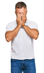 Handsome muscle man wearing casual white tshirt rubbing eyes for fatigue and headache, sleepy and...