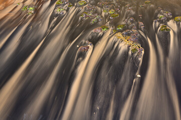 Serene water flowing over rocky streambed