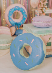 christmas decorations with candies, donnuts and cake in a photo studio 