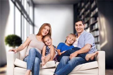 Happy young parents and kids resting at home