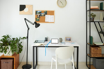 Home office desk of fashion designer in light spacious apartment