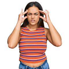 Young brunette woman wearing casual clothes with hand on head for pain in head because stress....