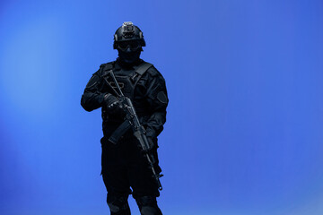 Soldier in black uniforms with weapon in studio. Concept Military warrior army tactical force to fight crime in city