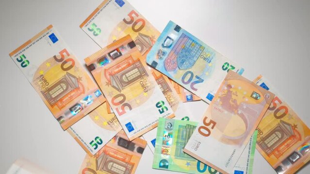 Banknotes of 20, 50, 100 euros fall one on a table. Background concept made of money. High quality photo