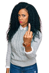 Middle age african american woman wearing casual clothes showing middle finger, impolite and rude...