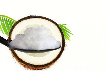 organic coconut cream oil in spoon with dry coconut and leaves in white background