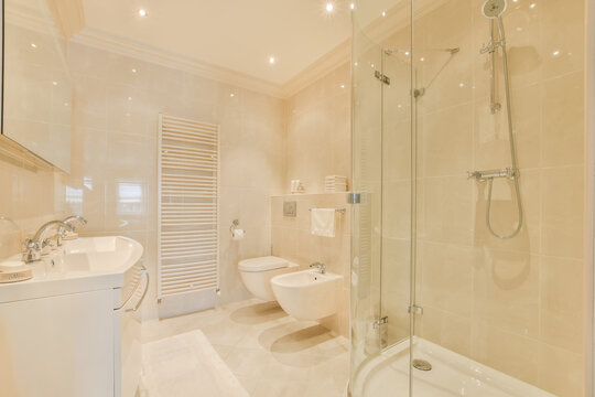 Bathroom with shower cabin and toilet bowls