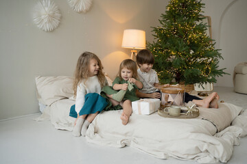 Children enjoying Christmas morning with presents