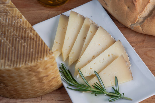 Artisan cheese slices with fresh herbs and bread