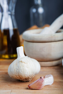 Fresh garlic bulb and cloves on a kitchen counter