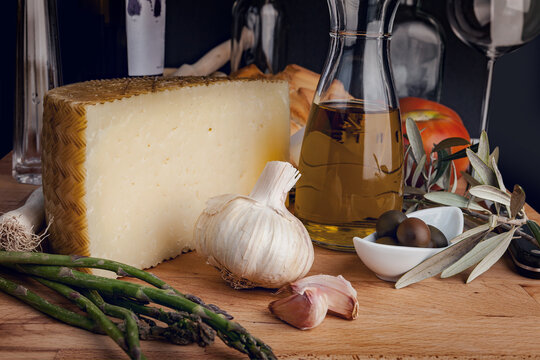 Gourmet cheese and ingredients on a rustic table