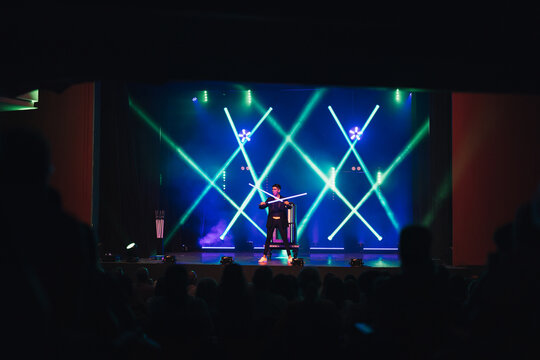 Magician performing magical trick in theater