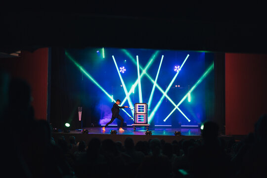 Magician performing trick on stage