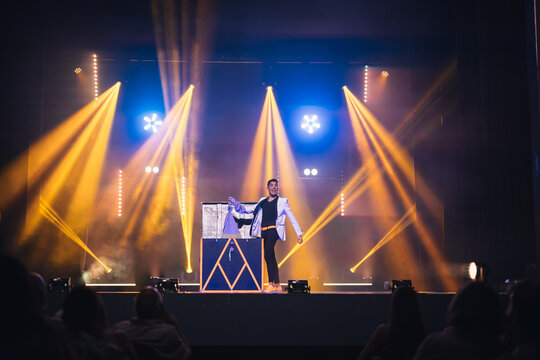 Illusionist taking stuff out of box on stage