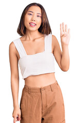 Young beautiful chinese girl wearing casual clothes showing and pointing up with fingers number four while smiling confident and happy.
