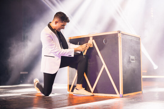Magician locking box on stage during performance