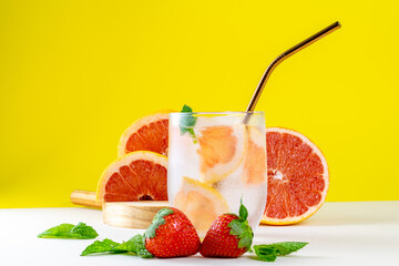 Refreshing Temptation: Strawberry and Grapefruit Water in a Crystal Glass